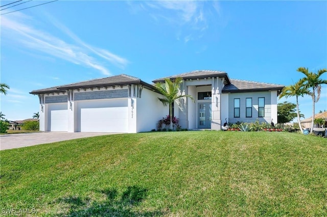 view of front of home featuring a front yard and a garage