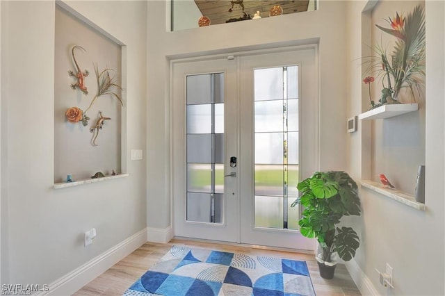 doorway featuring french doors and light hardwood / wood-style floors