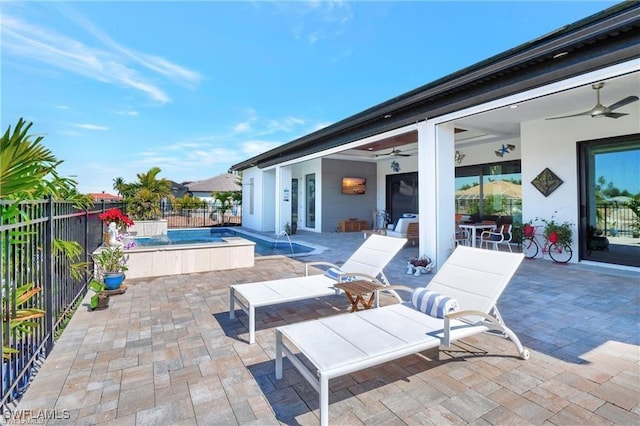 view of patio featuring a fenced in pool and ceiling fan