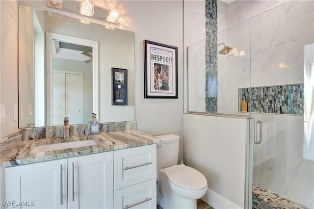 bathroom with vanity, toilet, and a shower with shower door