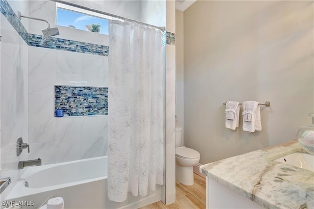 full bathroom featuring vanity, hardwood / wood-style floors, shower / bathtub combination with curtain, and toilet