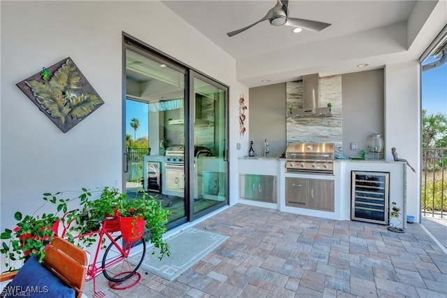 view of patio featuring ceiling fan, a grill, beverage cooler, and exterior kitchen