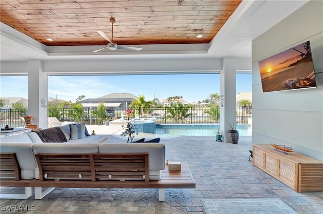 interior space featuring a fenced in pool, outdoor lounge area, and ceiling fan