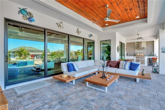 sunroom with ceiling fan, wooden ceiling, and a tray ceiling