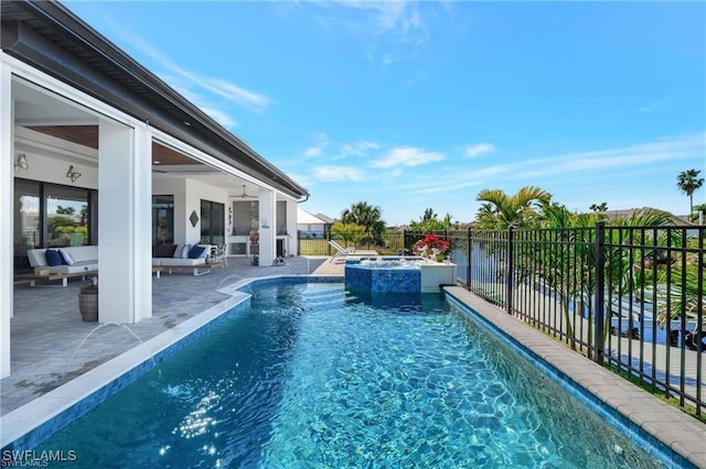 view of pool featuring ceiling fan, an in ground hot tub, a patio, and a water view