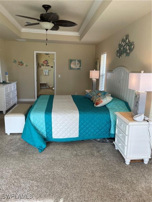 bedroom featuring carpet, ceiling fan, and a tray ceiling