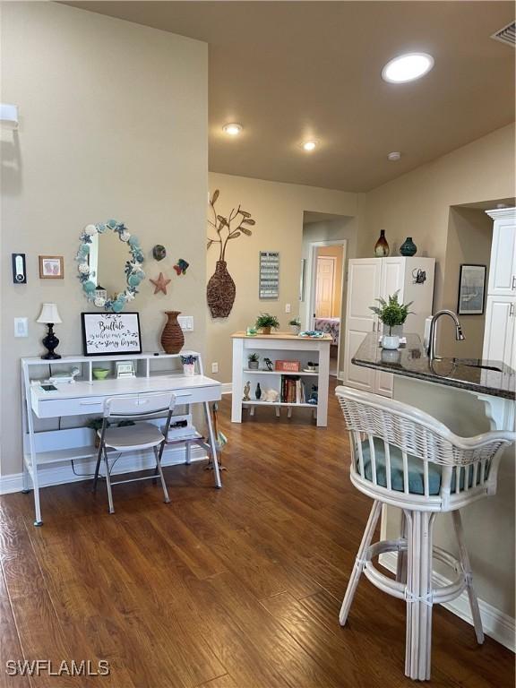 dining room with dark hardwood / wood-style flooring and sink