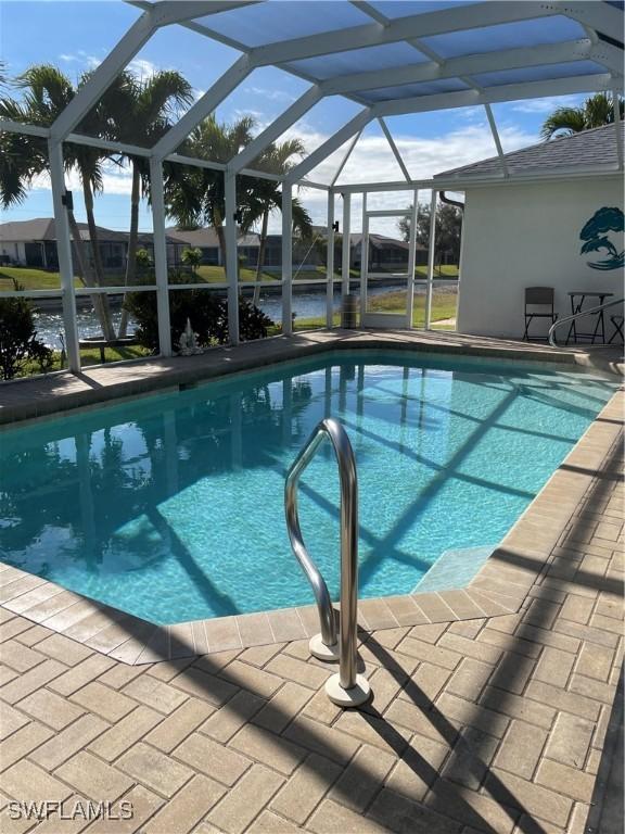 view of swimming pool featuring a patio area and a lanai