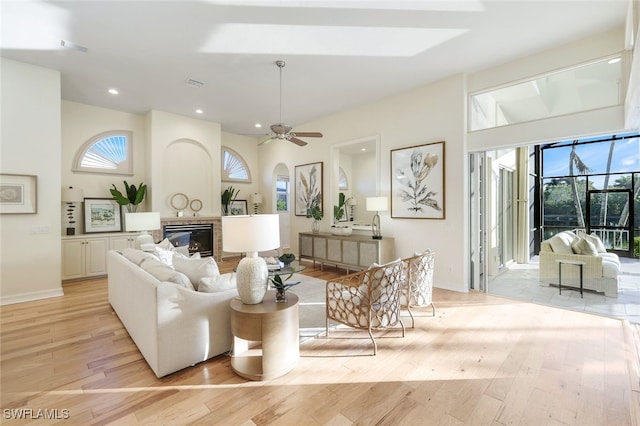 living room featuring ceiling fan and light hardwood / wood-style floors