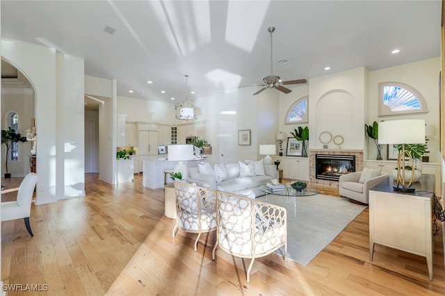 living room with ceiling fan and light hardwood / wood-style flooring