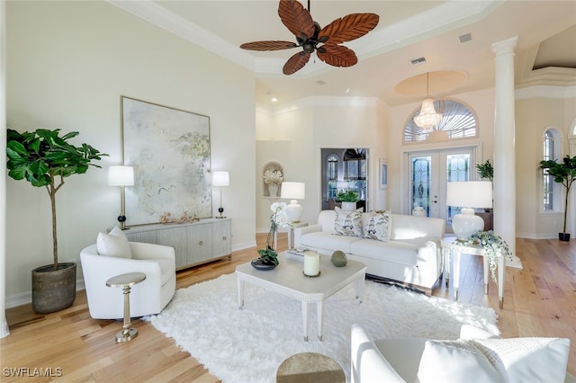 living room with ceiling fan, french doors, ornamental molding, and light hardwood / wood-style flooring