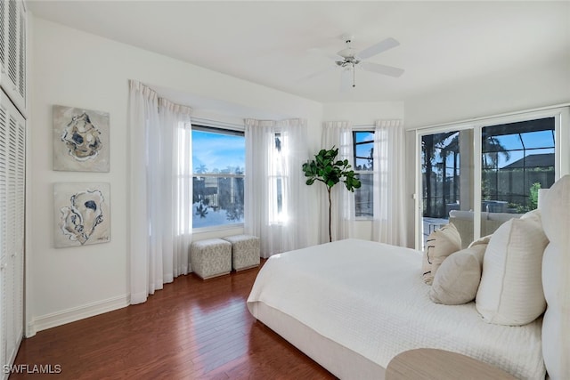 bedroom with dark hardwood / wood-style floors, ceiling fan, and access to exterior