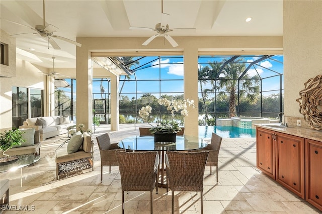 sunroom featuring a swimming pool, plenty of natural light, and sink