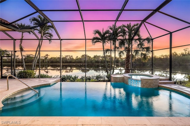 pool at dusk featuring glass enclosure, a patio area, and a water view