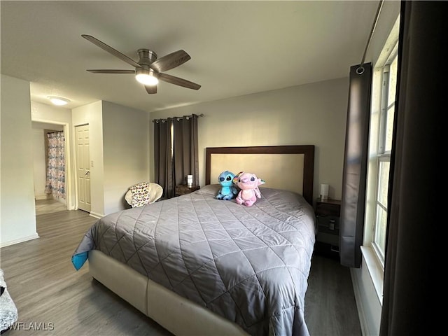 bedroom with ceiling fan and dark hardwood / wood-style flooring