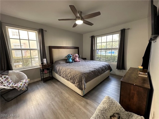 bedroom with ceiling fan and wood-type flooring