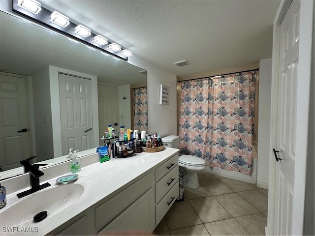 full bathroom with shower / bath combo, tile patterned flooring, a textured ceiling, toilet, and vanity