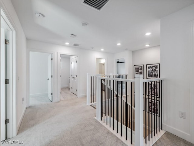 corridor with light colored carpet