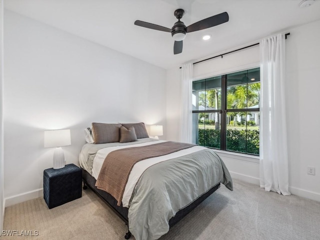 bedroom featuring light carpet and ceiling fan