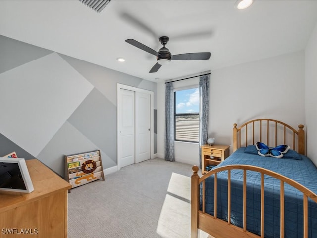 bedroom featuring ceiling fan, a closet, and light carpet