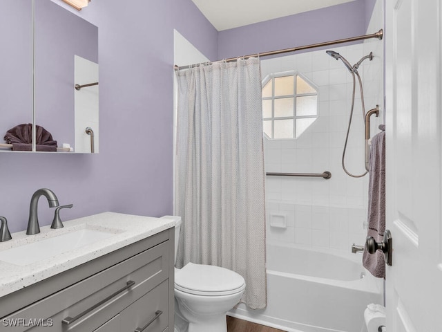 full bath featuring wood finished floors, vanity, toilet, and shower / bath combo with shower curtain