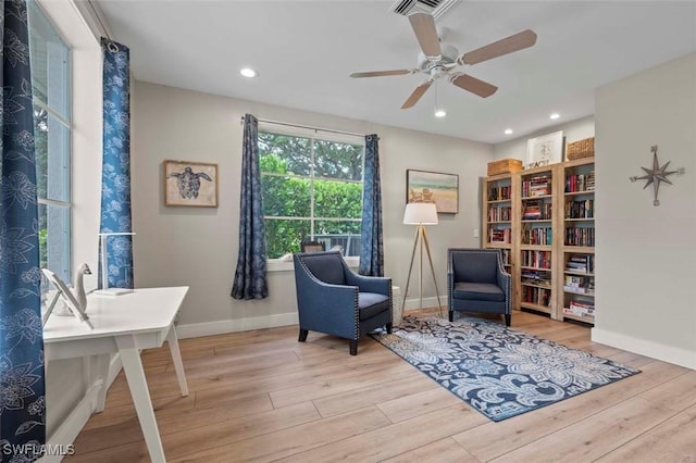 sitting room with baseboards, wood finished floors, visible vents, and recessed lighting