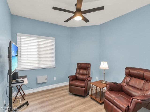 living area featuring ceiling fan and light wood-type flooring