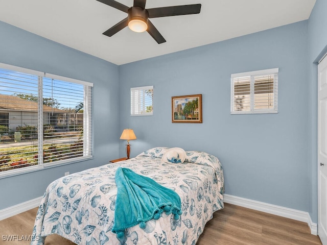 bedroom with ceiling fan and wood-type flooring