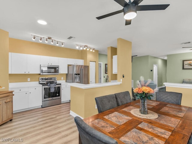 dining area with ceiling fan and light hardwood / wood-style floors