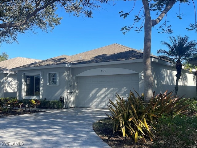 view of front of home with a garage and stucco siding