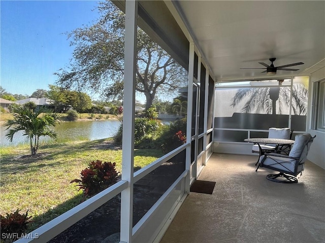 sunroom with a water view, ceiling fan, and a healthy amount of sunlight