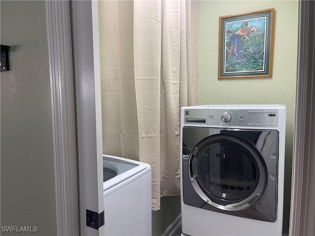 laundry area featuring washing machine and clothes dryer