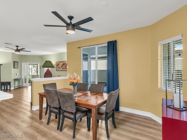 dining area with hardwood / wood-style flooring and ceiling fan