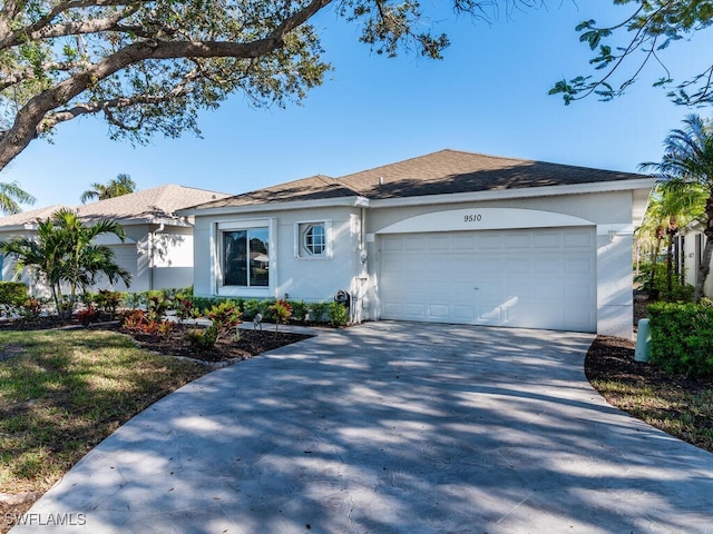 ranch-style home with driveway, an attached garage, and stucco siding