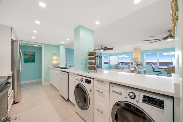 laundry room with ceiling fan, sink, and washer / dryer