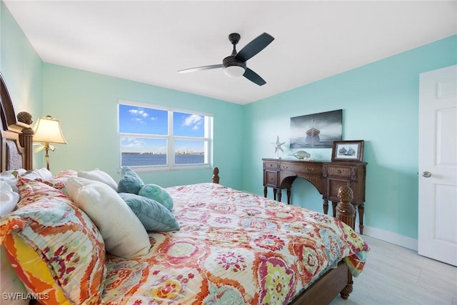 bedroom with ceiling fan and light hardwood / wood-style floors