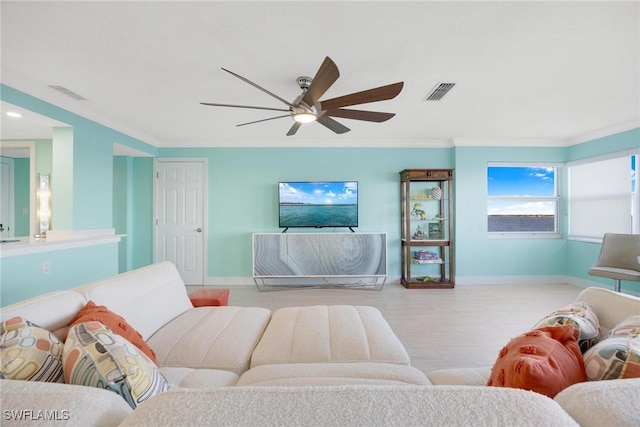 living room featuring light hardwood / wood-style floors, ceiling fan, and crown molding