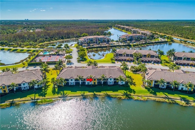 drone / aerial view with a water view and a residential view