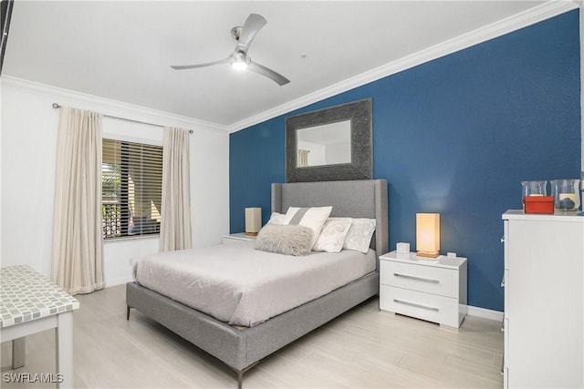 bedroom featuring light wood finished floors, ornamental molding, a ceiling fan, and baseboards