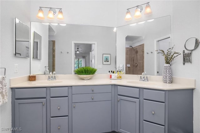 full bathroom with double vanity, a tile shower, and a sink