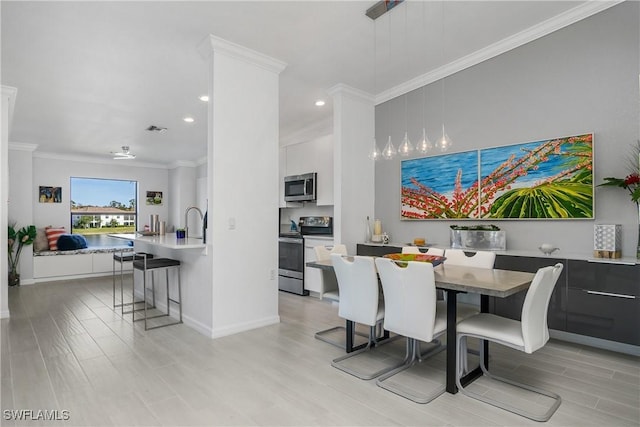 dining room with recessed lighting, visible vents, baseboards, ornamental molding, and light wood-type flooring