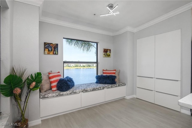 sitting room with light wood-style floors, crown molding, and baseboards