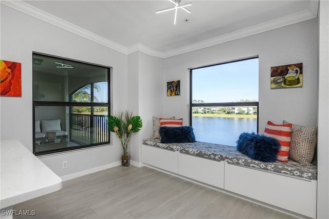 living area featuring baseboards, a water view, light wood-style flooring, and crown molding