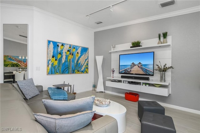 living room featuring track lighting, visible vents, and crown molding