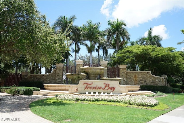 community / neighborhood sign featuring a lawn