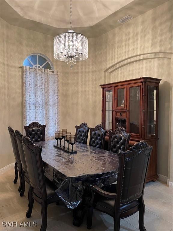 dining area with light tile patterned flooring and an inviting chandelier