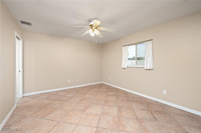 unfurnished room with ceiling fan and light tile patterned floors