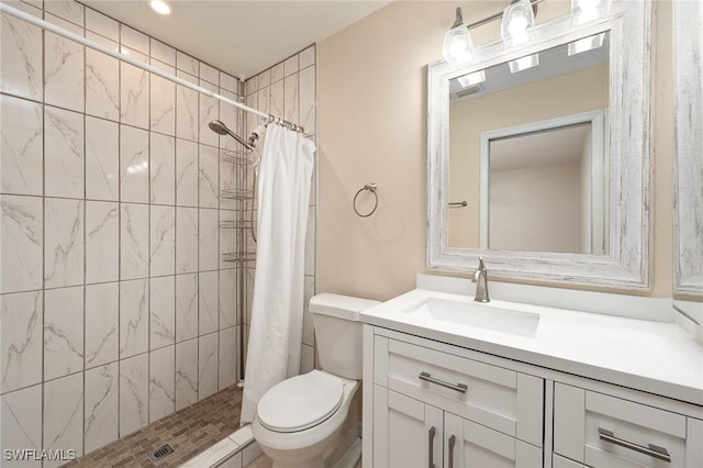 bathroom featuring curtained shower, vanity, and toilet