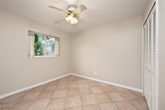 unfurnished bedroom featuring ceiling fan, a closet, and light tile patterned floors