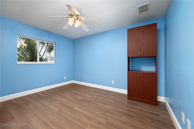 empty room featuring ceiling fan and hardwood / wood-style flooring